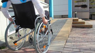 Woman in a wheelchair using a ramp
