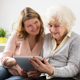 Grandmother learning how to use tablet
